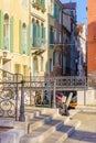 Bridge, canal and a tourist reading, in Venice