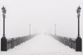 Bridge city landscape in foggy snowy winter day Royalty Free Stock Photo