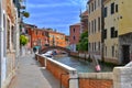 Bridge and colored houses on the sides of a small canal in Venice. Royalty Free Stock Photo