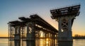 Majestic Bridge Under Construction at Golden Hour Over River Royalty Free Stock Photo