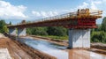 Bridge construction project over river with scaffolding and concrete pillars Royalty Free Stock Photo