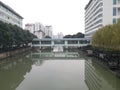 Bridge crossing the river being covered with roof with high buildings