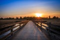 Bridge crossing sea at sunset Royalty Free Stock Photo