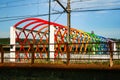 Bridge decorated with colored arches to access the train tracks