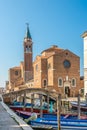 Bridge Filippini over Vena canal with Church of Holy Trinity in Chioggia - Italy