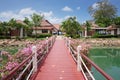 Bridge with flowers across the bay in a tropical garden