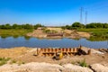 Bridge foundation made of metal piles on river coast, compressor placed at building site