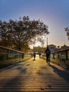 Bridge full of cyclists at sunset