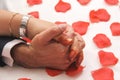 Bridge And Groom Hold Hands On Rose Leafs