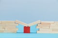 Bridge help. Safety net. Financial help. Business support. Wooden planks on red cube between bridge gap, copy space Royalty Free Stock Photo