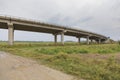 Countryside road passing under a highway bridge Royalty Free Stock Photo