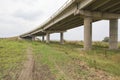 Countryside road passing under a highway bridge Royalty Free Stock Photo