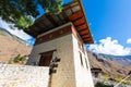 Bridge house of a suspension bridge over the fast flowing mountain river in the Himalayas of Bhutan. Traditional Bhutanese Royalty Free Stock Photo