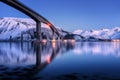 Bridge with illumination, snow covered mountains, blue sky Royalty Free Stock Photo