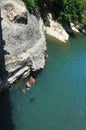 Boys Jumping from the bridge to the river below