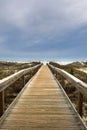 Bridge Leading to Beach on Ocean Shore Royalty Free Stock Photo