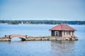 Bridge leading to an isolated cottage in a rocky island at the Thousand Islands during the daytime. Ontario, Canada