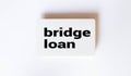BRIDGE LOAN text on a notebook with clipboard and calculator on a chart background Royalty Free Stock Photo