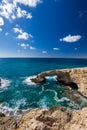 Bridge of Lovers or Monk seal arch, stone cliffs in the Mediterranean sea in Ayia Napa, Cyprus. Vertical frame Royalty Free Stock Photo