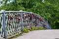 A bridge with many padlocks on the railing