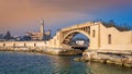 Bridge in the sea at the tea island of Montazah park and the Royal palace in the far distance at sunrise time, Alexandria, Egypt