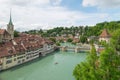 Bridge next to church crossing river Aare in old city center in Bern