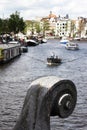 Bridge ornament closeup, boats on Amstel, Amsterdam