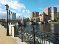 A bridge over a body of water with a city in the background Royalty Free Stock Photo