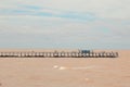 Bridge over The Brown RÃÂ­o de la Plata in Argentina, Buenos Aires with a small blue house and blue sky