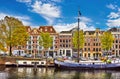 Bridge over channel in Amsterdam Netherlands houses river Amstel landmark old european city spring landscape. Royalty Free Stock Photo