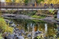 Bridge over colored water. Autumn reflections on the Wenatchee River. Covered by a foot bridge and a girl with bright red hair Royalty Free Stock Photo