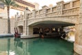Bridge over the decorative water channel flowing through the courtyard of the bazaar and shopping mall - Souk Madinat Jumeirah in