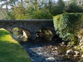 The bridge over the famous Glendalough Monastic site with its round tower and cemetery in the Wicklow mountains in County Wicklow, Royalty Free Stock Photo