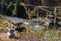 Bridge over the fast flowing mountain river in the Himalayas of Bhutan. River winds through the valley, a suspension bridge Royalty Free Stock Photo