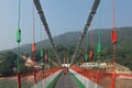 Bridge over Ganga river, Ram Jhula, Rishikesh. People crossing Ram Jhula bridge. Royalty Free Stock Photo