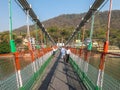 Bridge over Ganga river, Ram Jhula, Rishikesh. People crossing Ram Jhula bridge Royalty Free Stock Photo