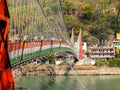 Bridge over Ganga river, Ram Jhula, Rishikesh. People crossing Ram Jhula bridge Royalty Free Stock Photo