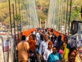 Bridge over Ganga river, Ram Jhula, Rishikesh. People crossing Ram Jhula bridge Royalty Free Stock Photo