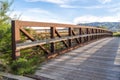 Bridge over a lake with view of mountain and valley under blue sky and clouds Royalty Free Stock Photo