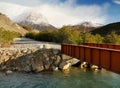 Bridge over mountain river. Snowy mountains. Lago Argentino, Patagonia Royalty Free Stock Photo