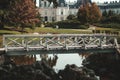 Bridge over a pond with a white castle in the background Royalty Free Stock Photo