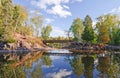 Bridge over a quiet stream in fall Royalty Free Stock Photo