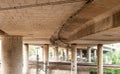 View under bridge over railway tracks with concrete columns