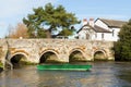 Bridge over River Avon Christchurch Dorset England UK with green boat Royalty Free Stock Photo