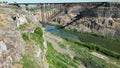 Bridge over a river flowing along the cliffs Royalty Free Stock Photo