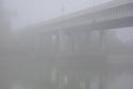 Bridge over the river in the fog. Lonely man under the bridgeÃÂ¼ Royalty Free Stock Photo