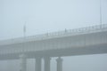 Bridge over the river in the fog. Lonely man under the bridgeÃÂ¼ Royalty Free Stock Photo
