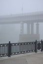 Bridge over the river in the fog. Lonely man under the bridgeÃÂ¼ Royalty Free Stock Photo