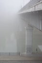 Bridge over the river in the fog. Lonely man under the bridgeÃÂ¼ Royalty Free Stock Photo