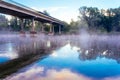 Bridge over the river and fog over the water. Royalty Free Stock Photo